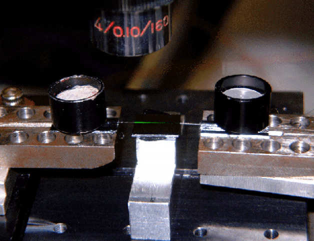 Erbium-doped channel waveguide silica-on-silicon optical  amplifier formed in sol-gel glass. The green streak arises from upconversion