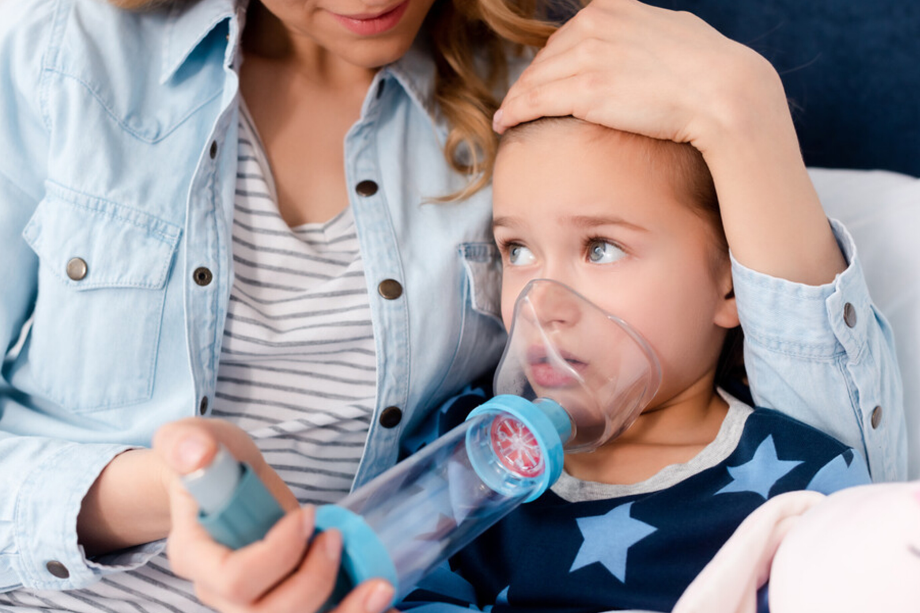 A photo of a child using a combination inhaler for asthma