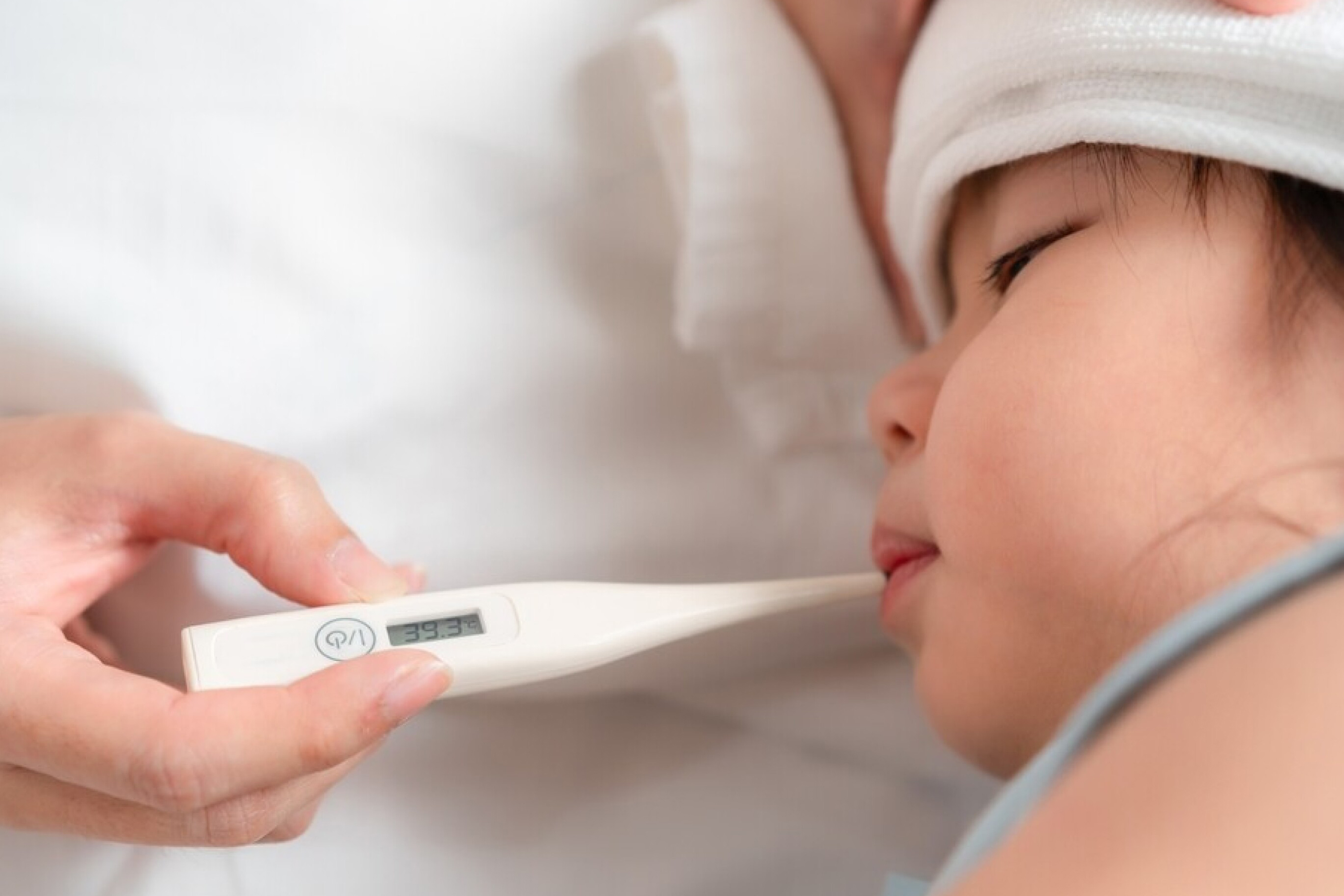 A photo of a child having temperature taken